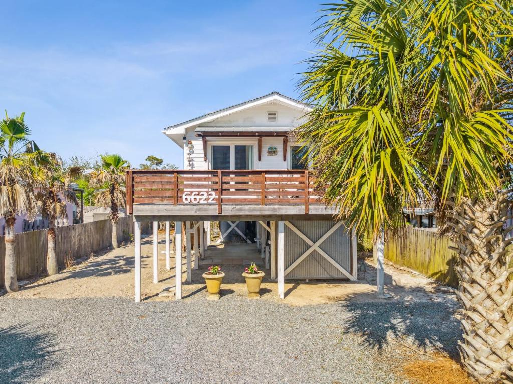 a house with a wooden bridge in front of a house at Casa de la Playa - 2 Bedroom Beach House in Panama City Beach