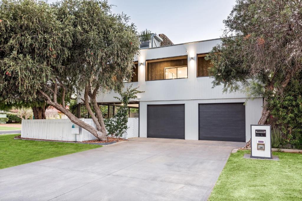 a large white house with two garage doors at Rooftop Retreat in Dunsborough