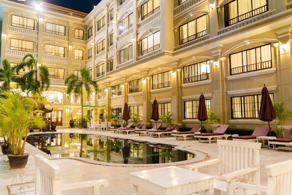 a hotel with a pool in the middle of a building at Monoreach Angkor Hotel in Siem Reap