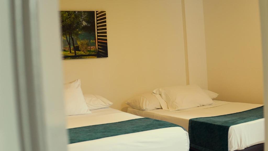 Postel nebo postele na pokoji v ubytování Hotel Campestre Villa Mary