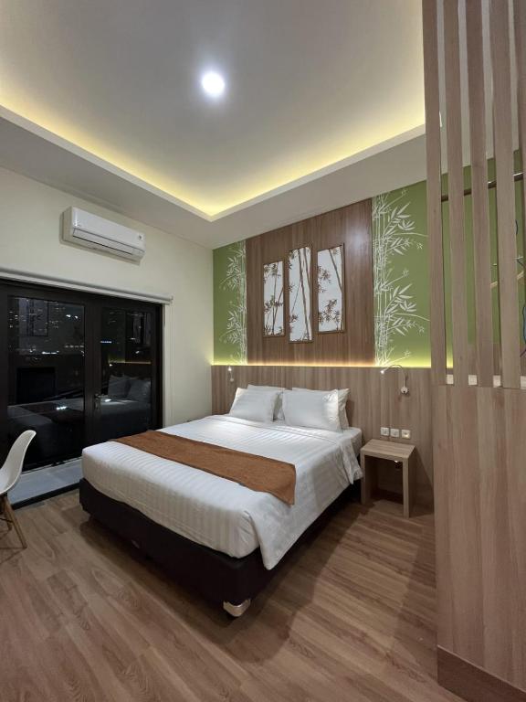 Postel nebo postele na pokoji v ubytování D'Bamboo Suites