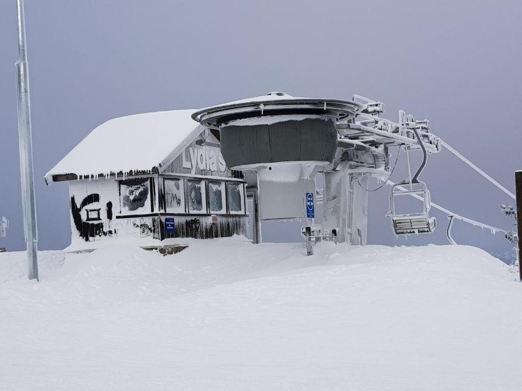 a ski lift with snow on the ground at Peak 105 in Mount Buller