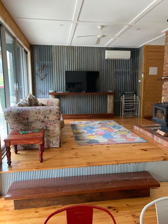 a living room with a couch and a rug at Taylor Bay Country Club in Eildon