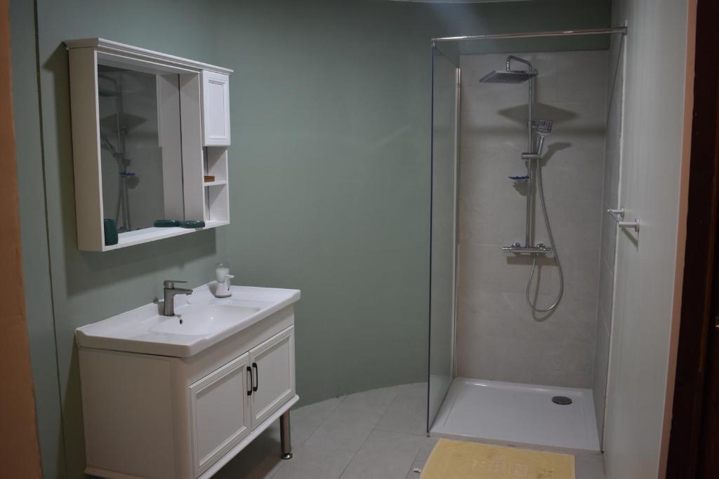 a bathroom with a sink and a shower at Fare Aute Beach in Vaianae