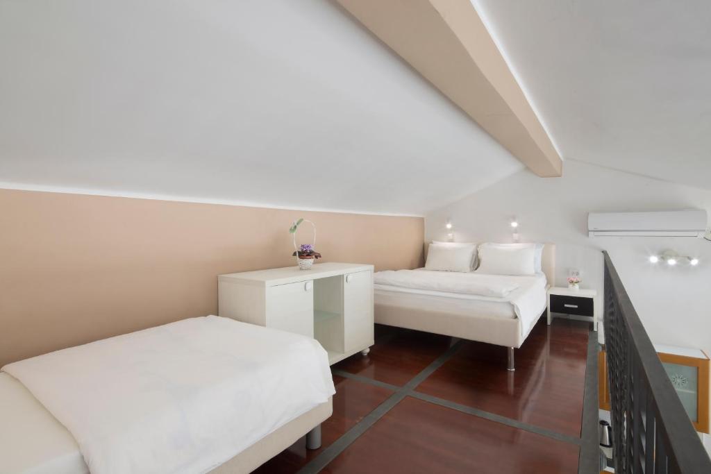 Postel nebo postele na pokoji v ubytování Spa Resort Bečići