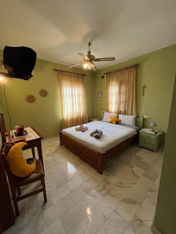 a bedroom with a bed and a table and a ceiling at Valenthia in Agios Ioannis Pelio