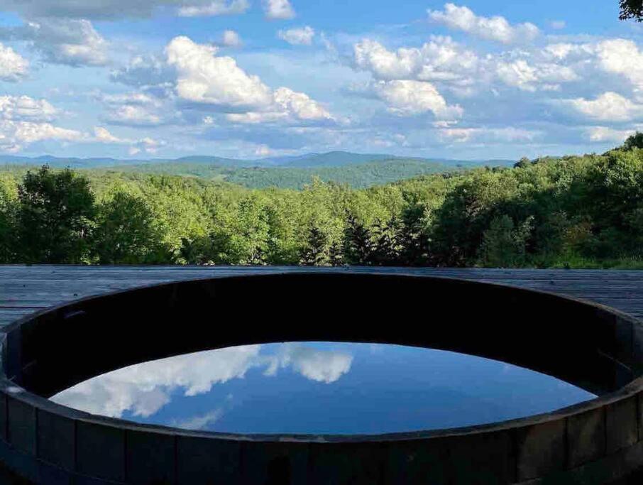 a circular pool on a roof with a view of the sky at Catskills Barn Apt on 34 acre Estate with Mountain views in Delhi