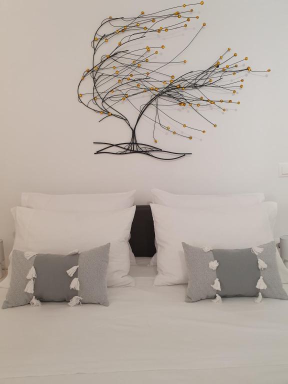 a room with pillows and a sculpture of a tree at Kalamia's cozy apartment in Pirgos