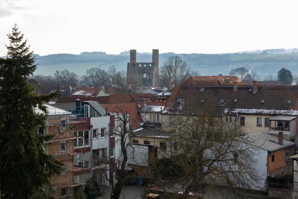 a view of a city with buildings and a church at Hotel Anker in Saalfeld