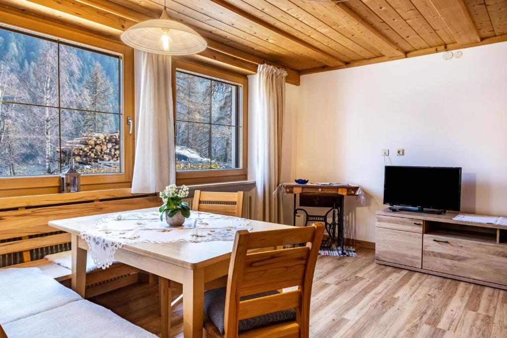 a dining room with a table and a television at Adlerhorst Amsel in Santa Valpurga