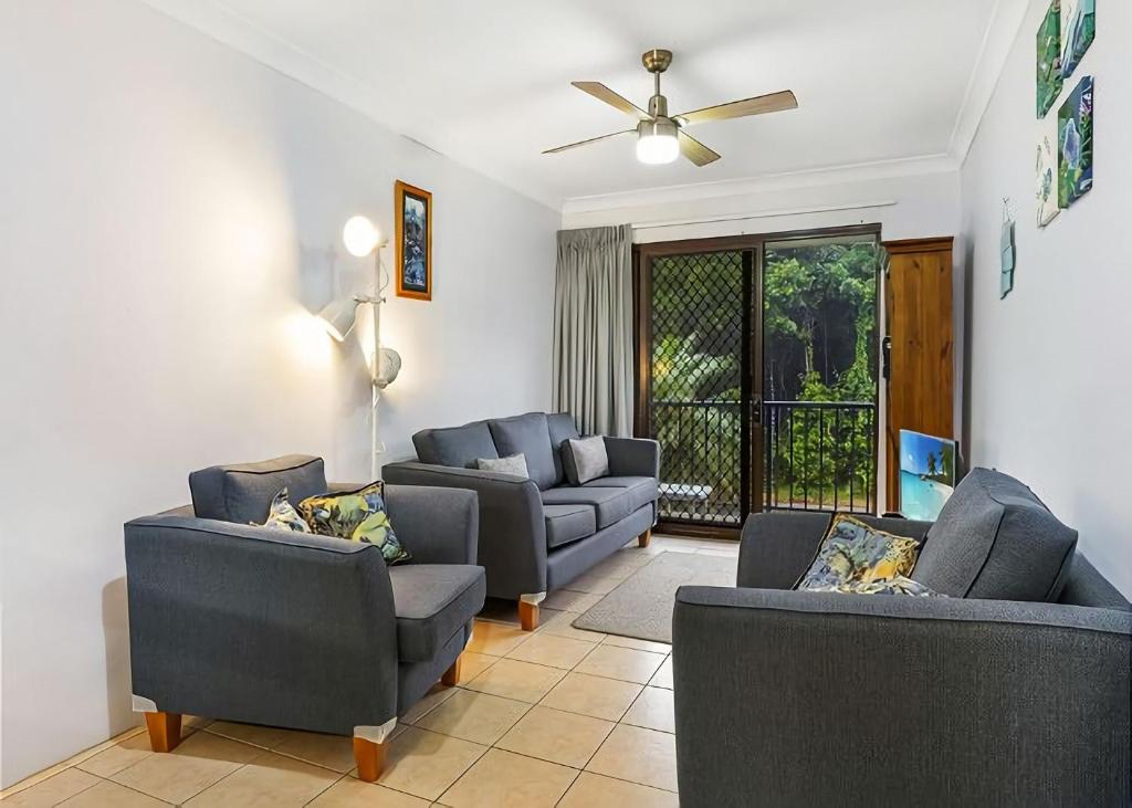 a living room with couches and a ceiling fan at Ocean Sands 5 in Sawtell