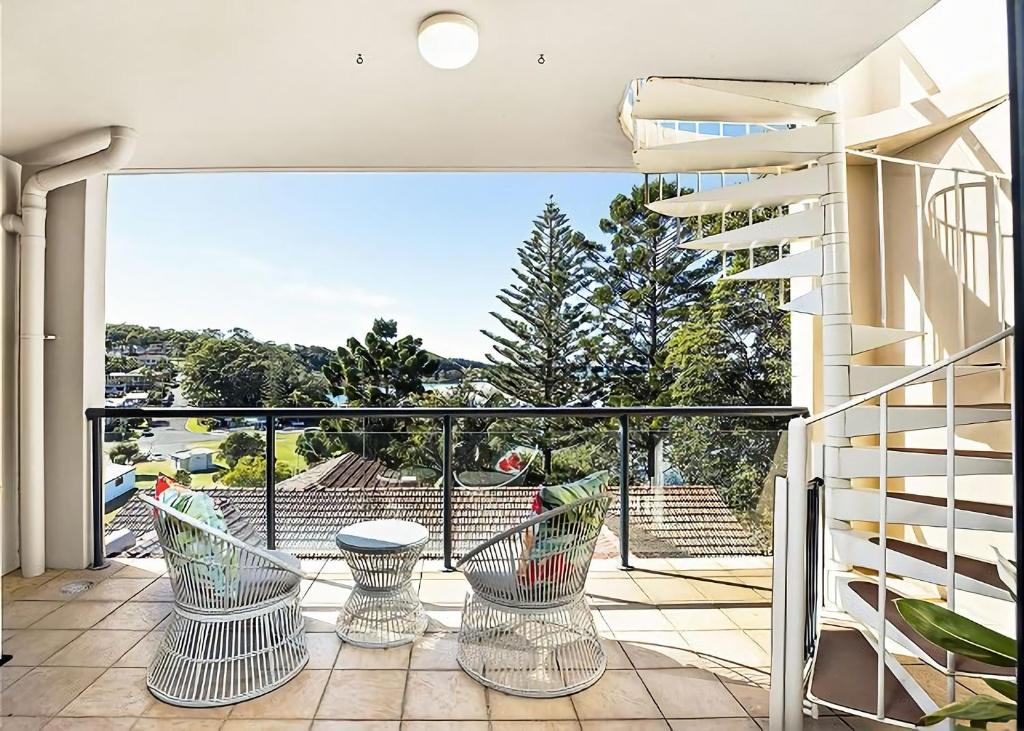 a balcony with a view of a building at Ocean Pines in Nambucca Heads