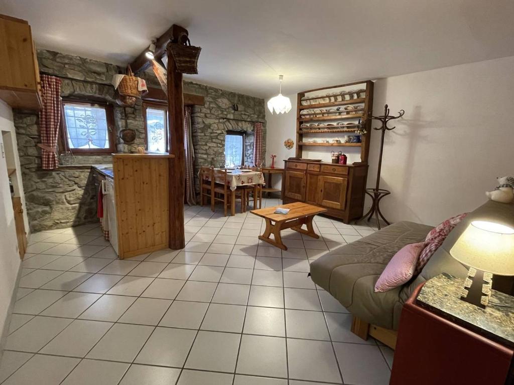 a living room with a couch and a table at Maison Vallouise, 2 pièces, 4 personnes - FR-1-330G-140 in Puy-Saint-Vincent