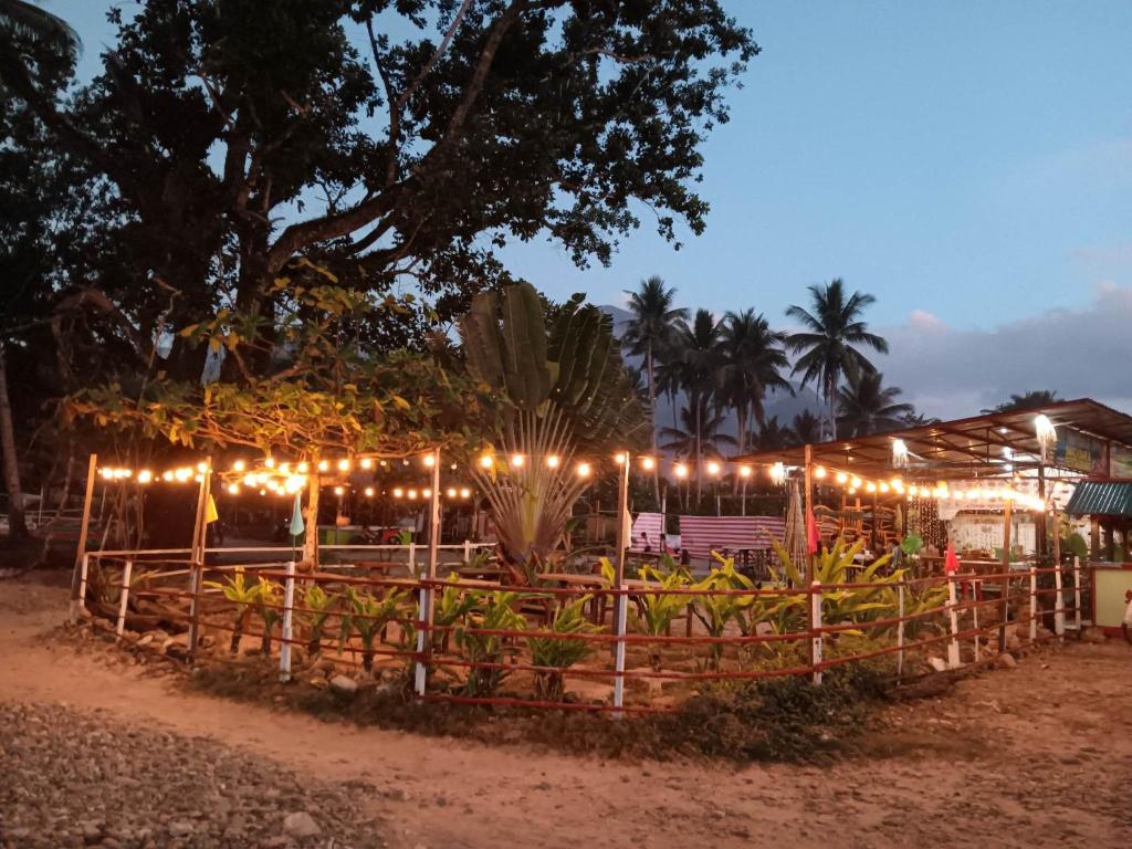 a restaurant with lights in front of a fence at Casa Leonora in Sabang