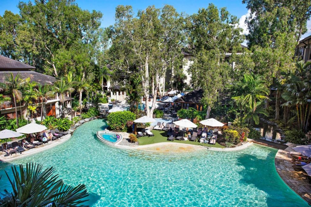 an aerial view of a pool at a resort at Temple 313 Spacious Modern 3 Bedroom Apartment Balinese Style Resort in Palm Cove