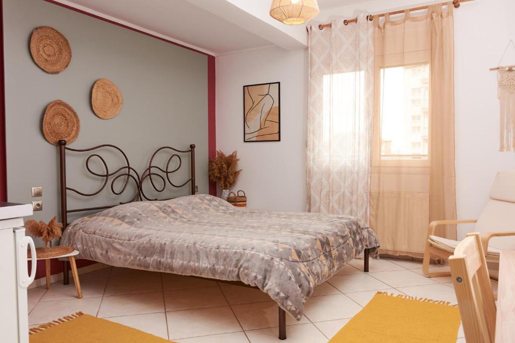 a bedroom with a bed and a chair and a window at Boho House Florina in Florina