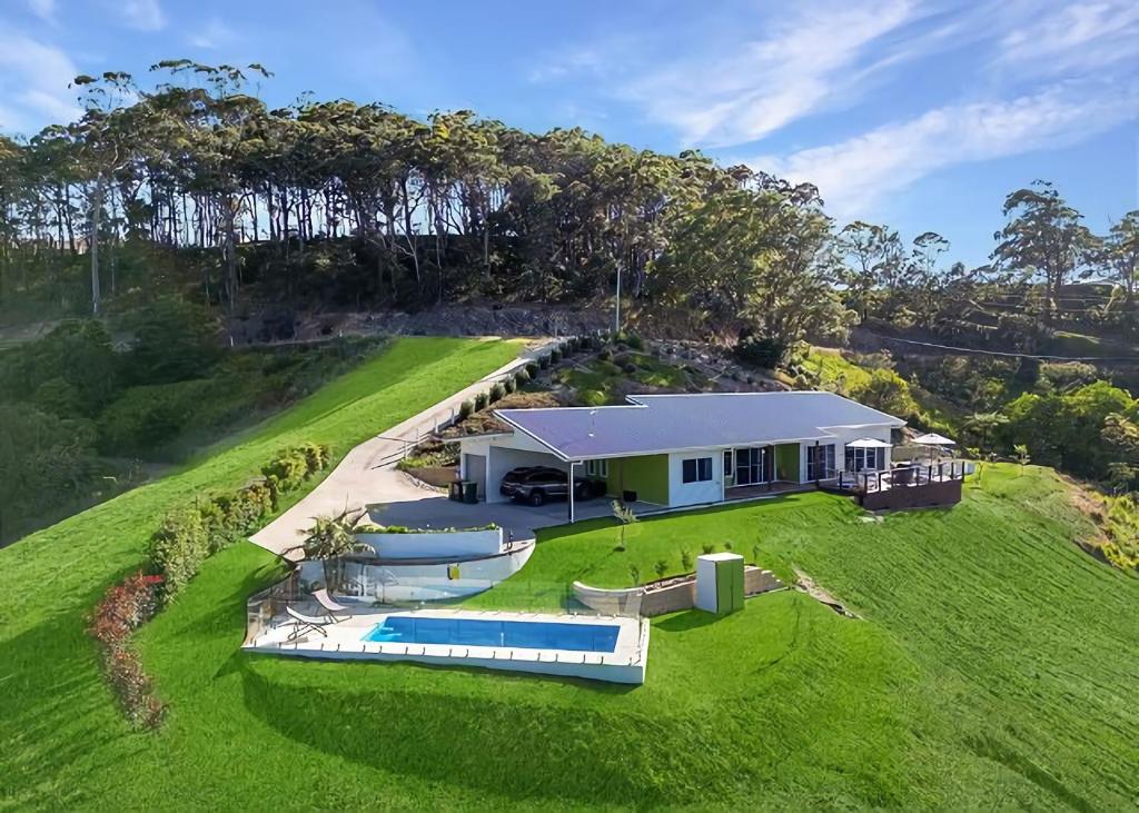 an aerial view of a house with a swimming pool at Ciao Korora The Classic in Kororo Basin