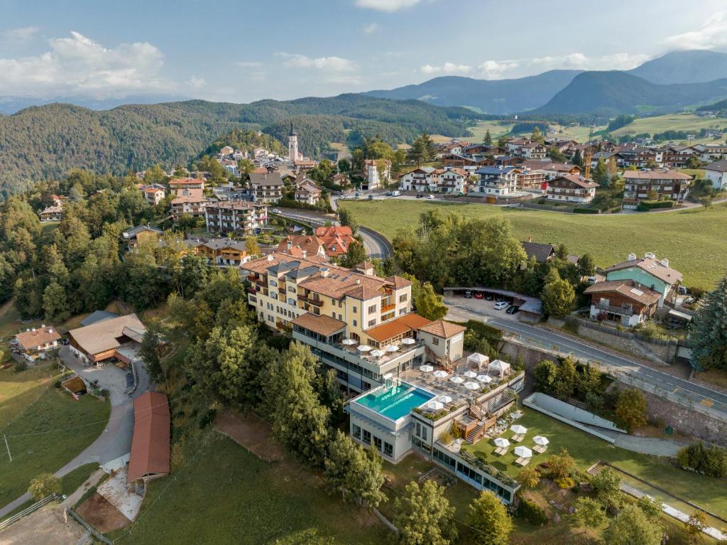 an aerial view of a town in the mountains at Hotel Alpenflora in Castelrotto