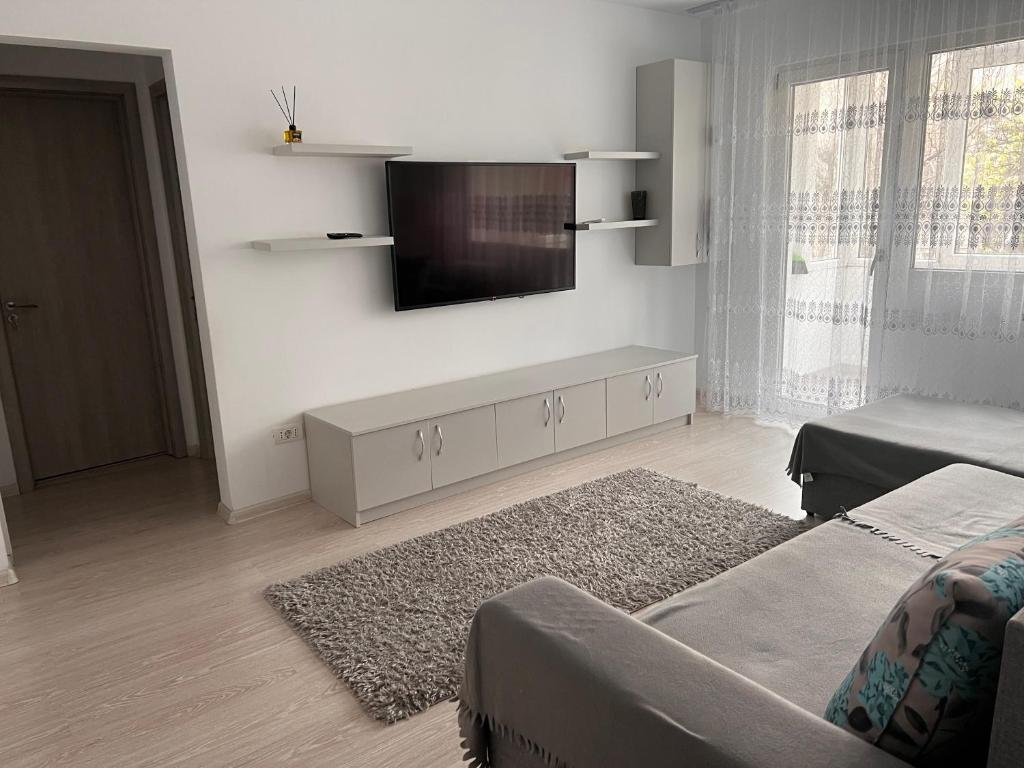 a living room with a flat screen tv on a wall at Apartament 2 camere in Bucharest