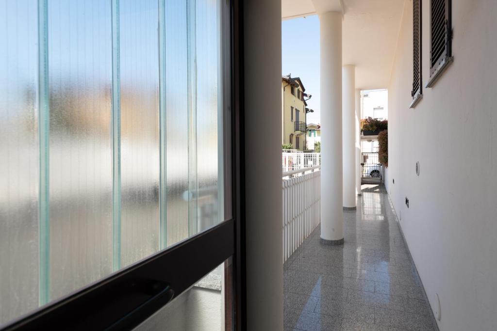 a view of a hallway from a room with a window at Bed&Business Nick Bellezza-San Siro Stadio-Rho Fiera in Settimo Milanese