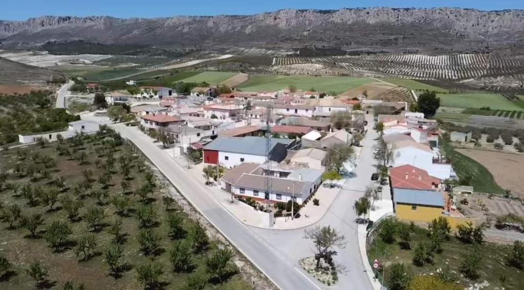 an aerial view of a town with mountains in the background at Casa Rural La Chicuela 