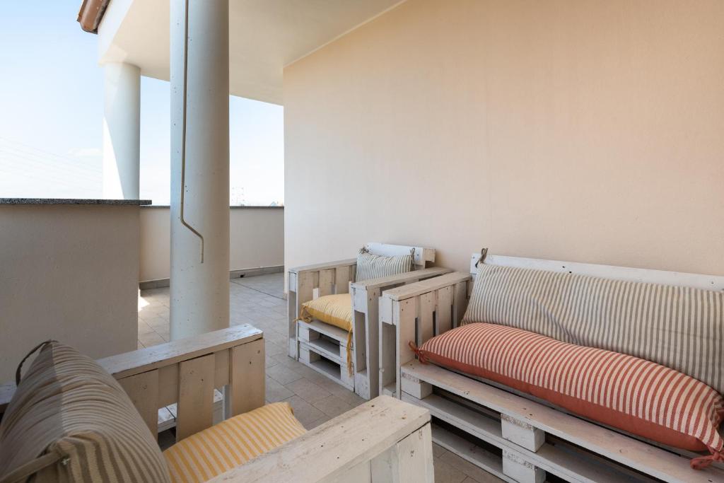 a room with wooden benches in a room at Bed&Business Nick Bellezza-San Siro Stadio-Rho Fiera in Settimo Milanese