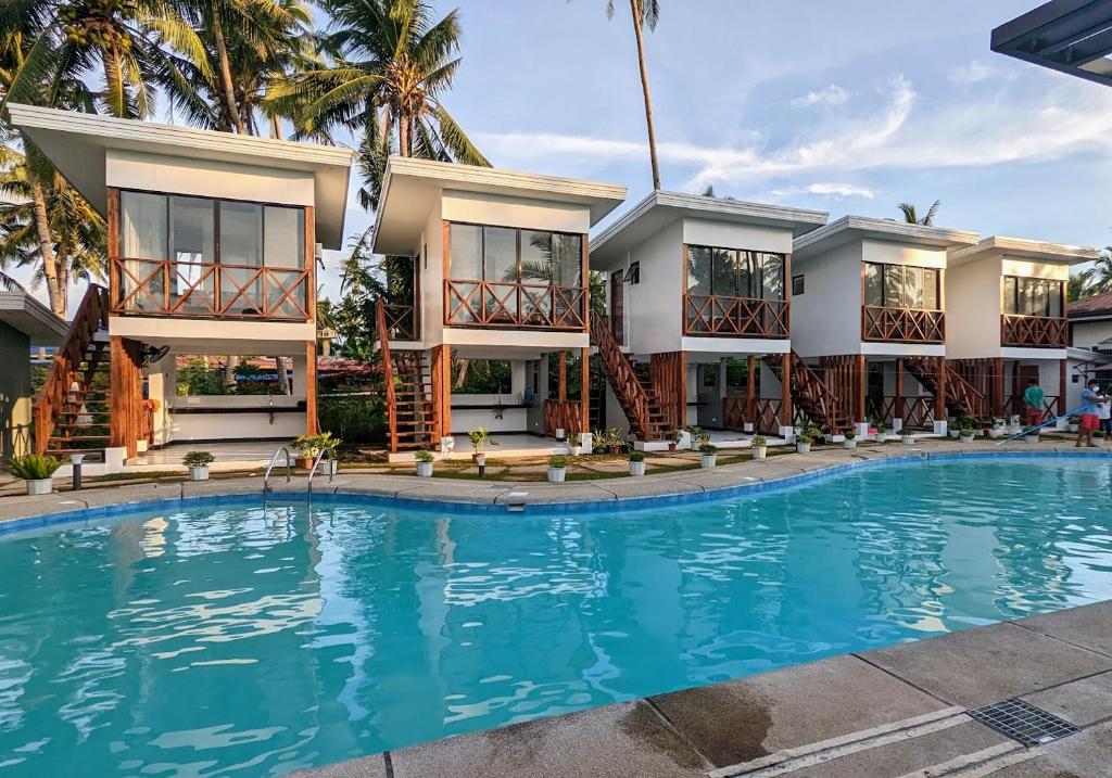 eine Villa mit einem Pool vor einem Haus in der Unterkunft Bakawan Hideaway Resort and Restaurant 