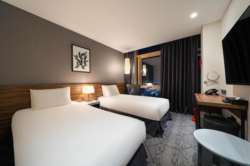 Postel nebo postele na pokoji v ubytování Staz Hotel Ulsan