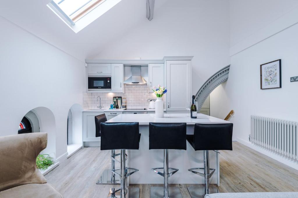 a kitchen and living room with a table and chairs at The Old Chapel Apartment in Chester