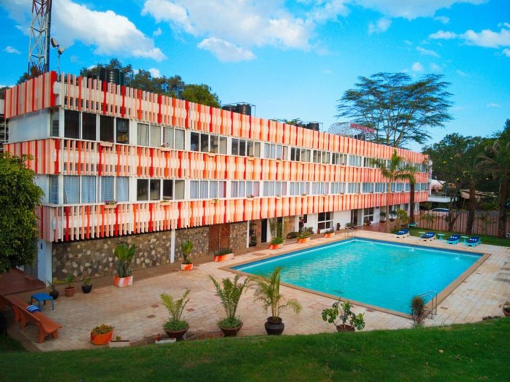 a building with a swimming pool in front of a building at Hotel Boulevard Nairobi, City Centre CBD in Nairobi