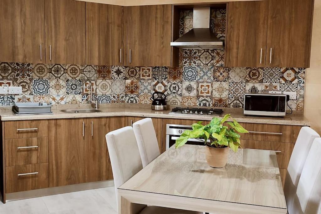 a kitchen with a table with a plant on it at 1bedroom Apartment Ghajnsielem in Għajnsielem