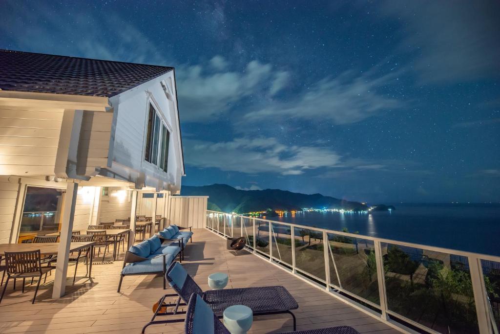 a balcony with a view of the ocean at night at BLUE EDEN 