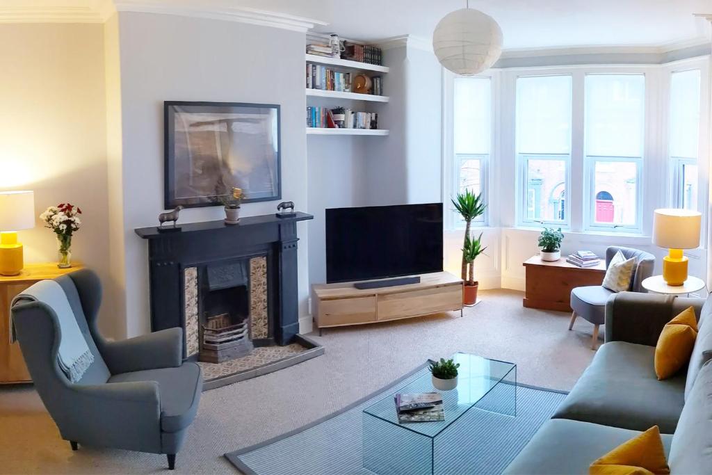 a living room with a fireplace and a tv at Townhouse Apartment Carlisle in Carlisle