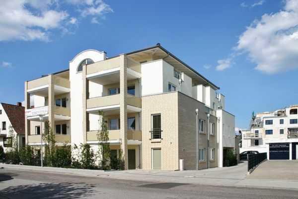 a large white apartment building on the side of a street at Wilhelm 7 in Timmendorfer Strand