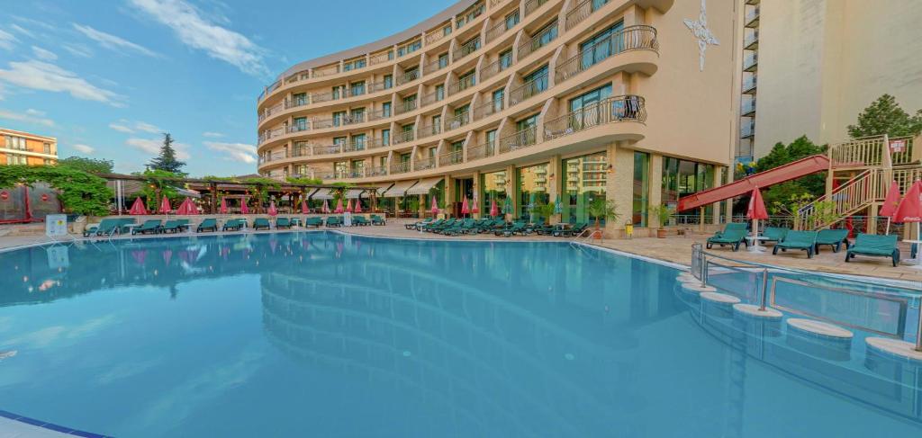 a large swimming pool in front of a hotel at Mena Palace Hotel - All Inclusive in Sunny Beach