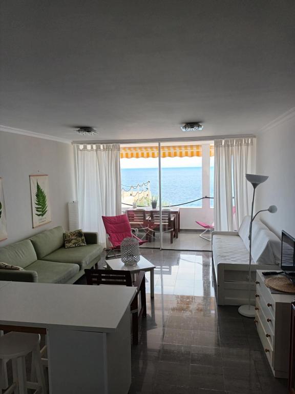 A seating area at Great oportunity Costa Adeje Holiday apartment first sea line Free Wifi