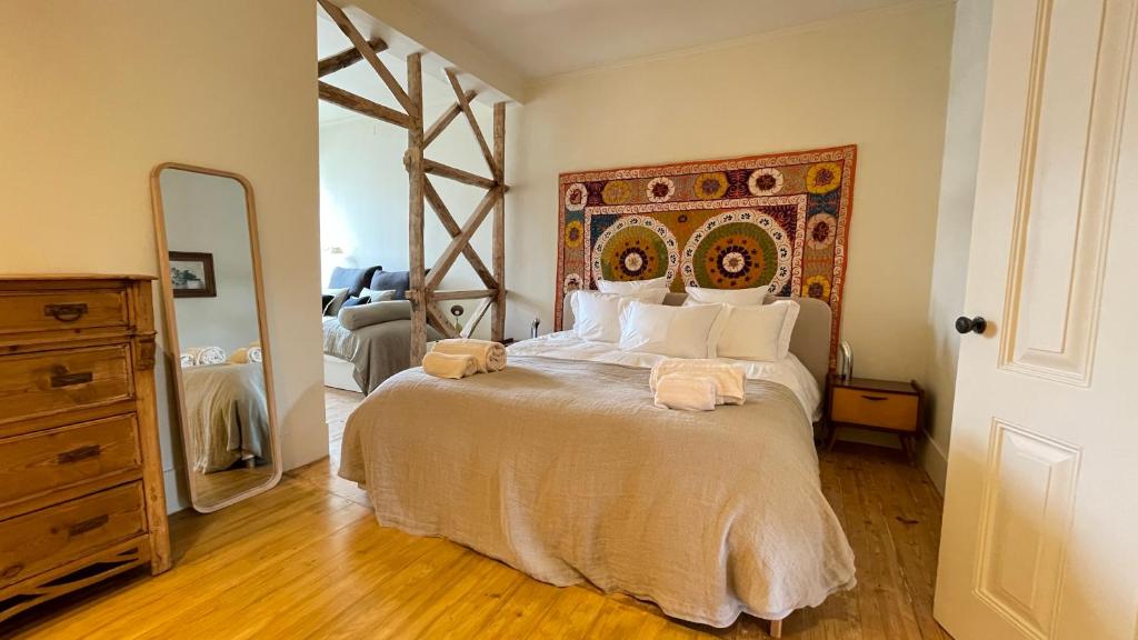 a bedroom with a large bed and a mirror at Eco Luxury apartment LISBOA-Campo de Ourique in Lisbon