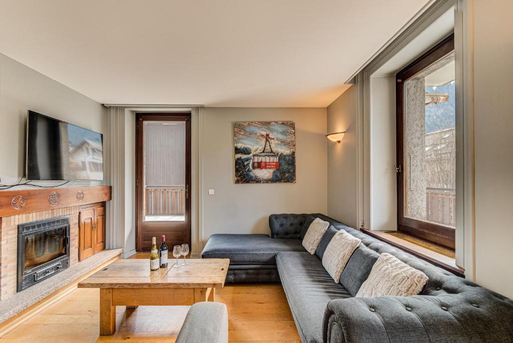 a living room with a couch and a table at APARTMENT PRESIDENT - Alpes Travel - Central Chamonix - Sleeps 12 in Chamonix