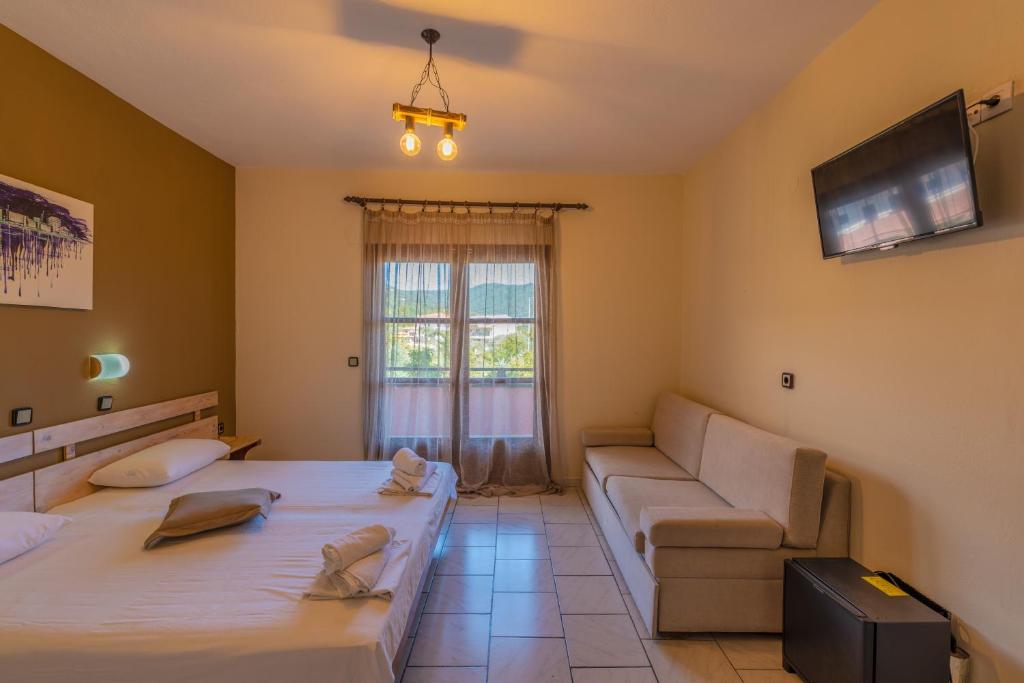Postel nebo postele na pokoji v ubytování Natasa Hotel