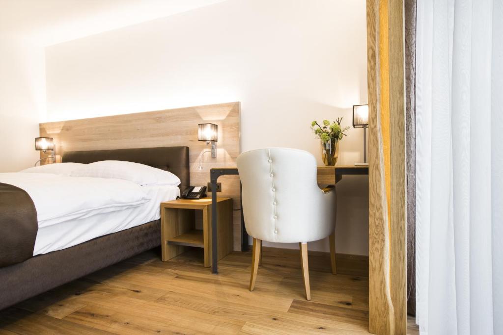 Postel nebo postele na pokoji v ubytování Romantik Hotel le Vignier