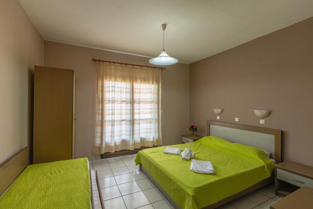 Postel nebo postele na pokoji v ubytování Natasa Hotel