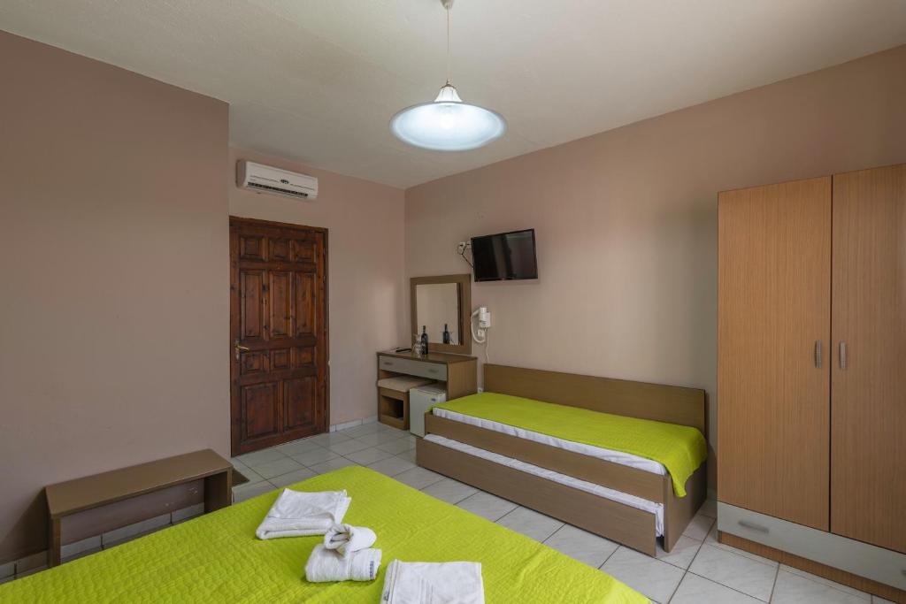 Postel nebo postele na pokoji v ubytování Natasa Hotel