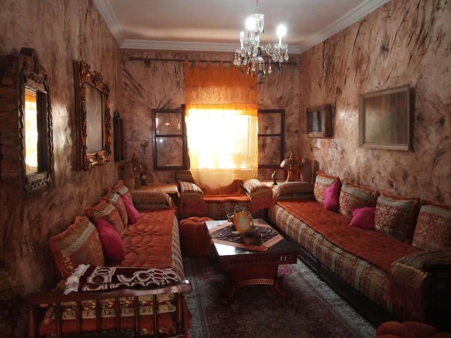a living room with a couch and a table at Margueritte vacancy apartment in Casablanca