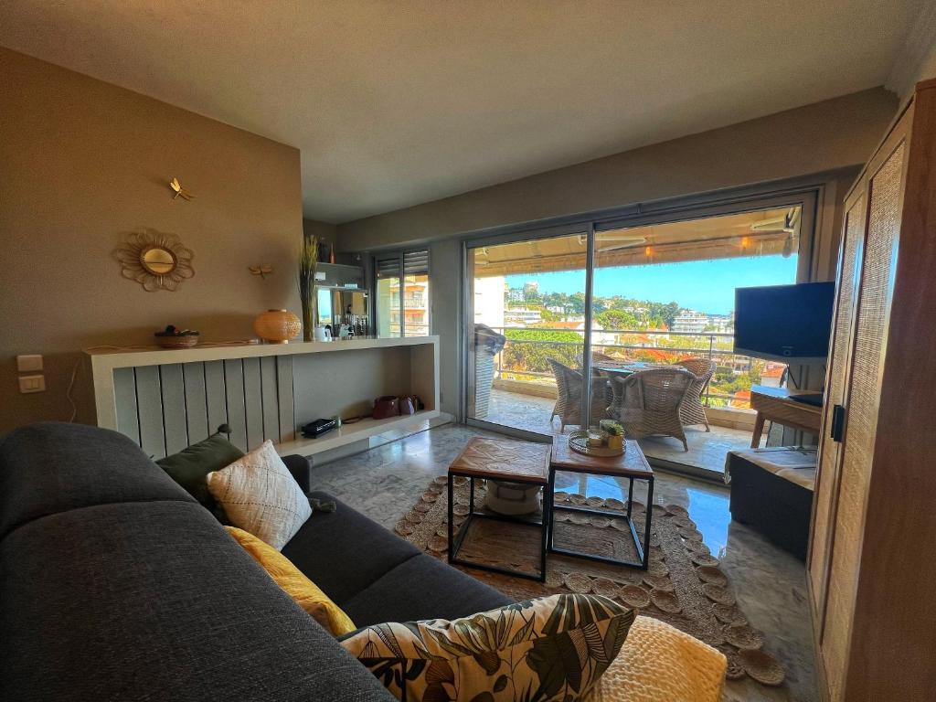 un salon avec un canapé et une télévision dans l'établissement Les Roses by Welcome to Cannes, à Cannes