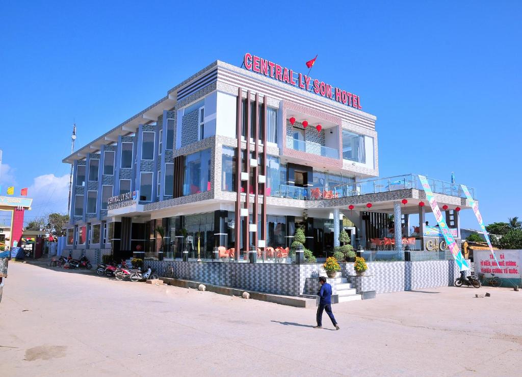 a man walking in front of a building at Central Ly Son in Ly Son