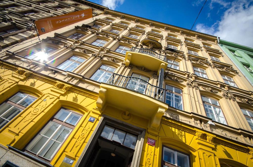 a yellow building with a balcony on the side of it at Wenceslas Square Hotel - Czech Leading Hotels in Prague