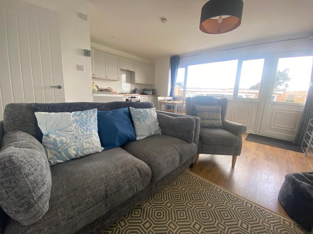 a living room with a couch and a chair at Beau - Brambles Chine, Colwell Bay - 5 star WiFi - Short walk to The Hut and beach - 1 night stays available - Ferry offers in Freshwater