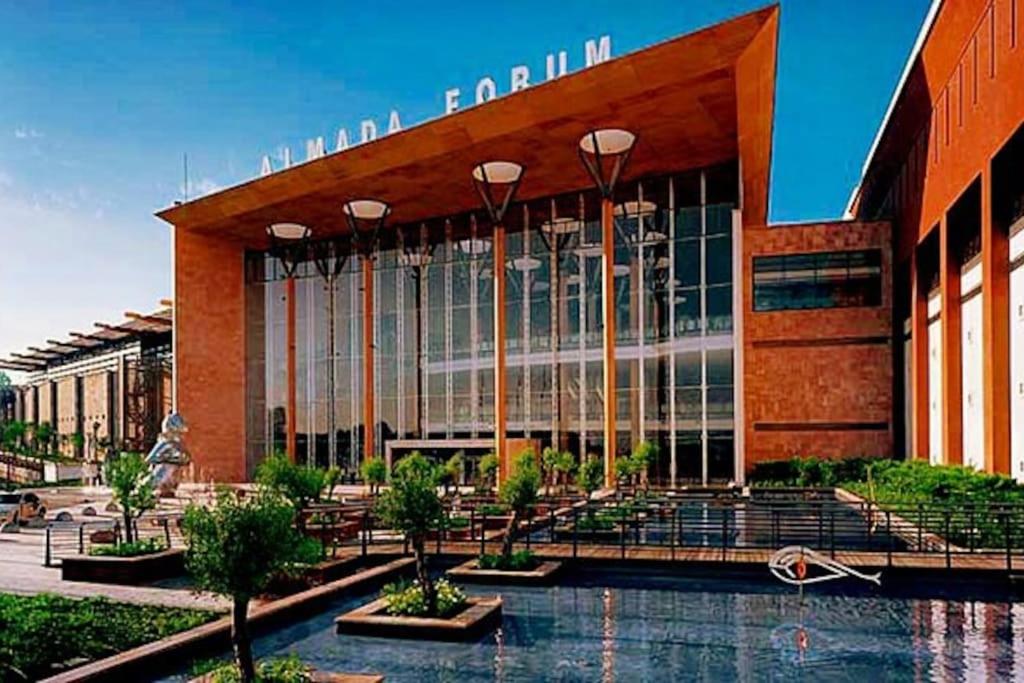 a large building with a fountain in front of it at Cocas House II - Almada in Almada