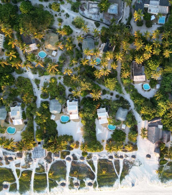 an aerial view of a resort with palm trees at Zanzibar White Sand Luxury Villas & Spa - Relais & Chateaux in Paje