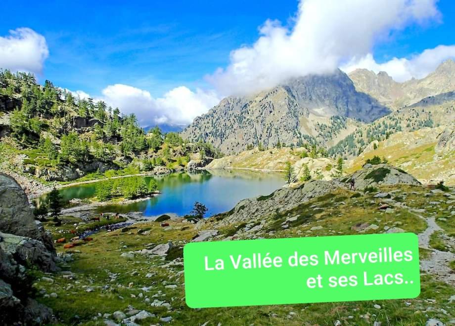 a lake in the mountains with a sign that reads lavalle des meadows at Gabriella in Menton